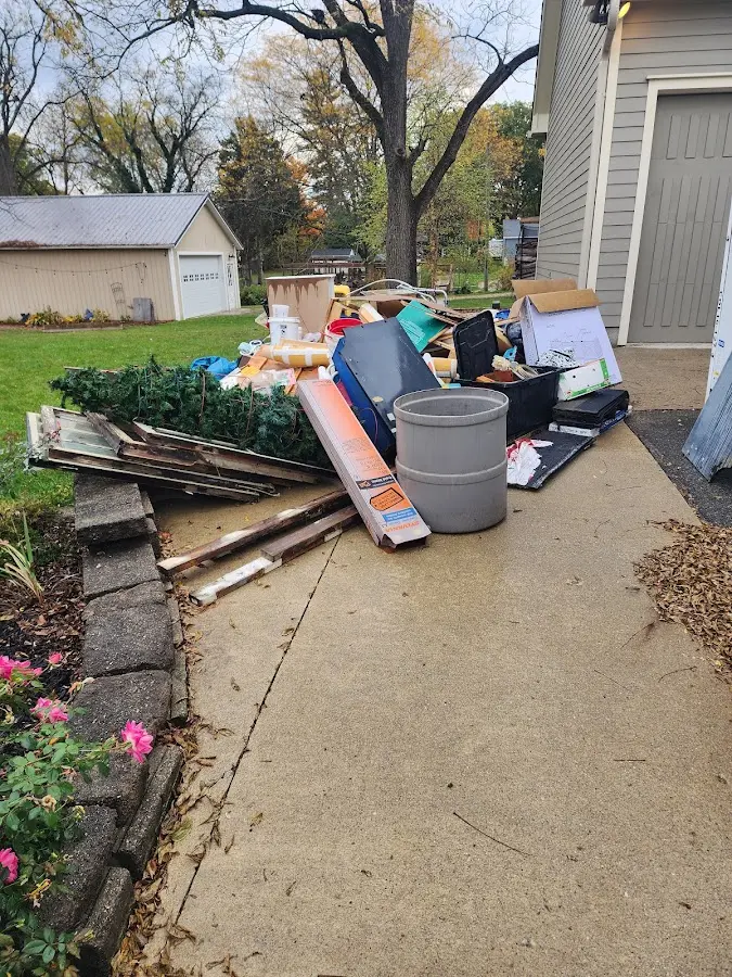 Dumpster being loaded with debris for Demolition Dumpster Rental in Oak Park Heights